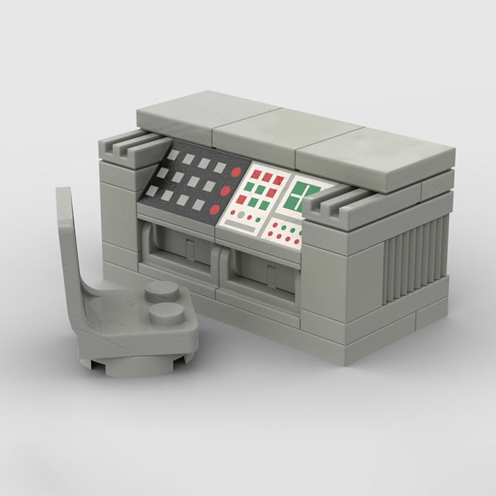 A small brick built control panel with colorful buttons and screens, paired with a small gray brick chair, all made from gray bricks on a white background.